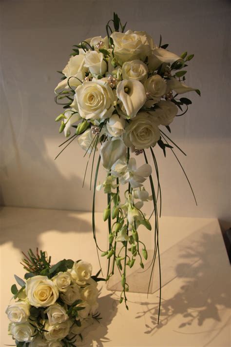 Brides Bouquet Of Roses Calla Lilies And Dendrobium Orchids Cascade