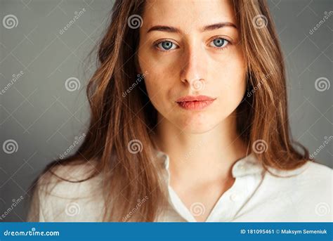 Serious Girl With Her Hair In Bright Clothes On A Gray Background
