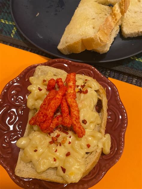 Two Plates With Some Food On Them And One Has Bread Sticks Sticking Out