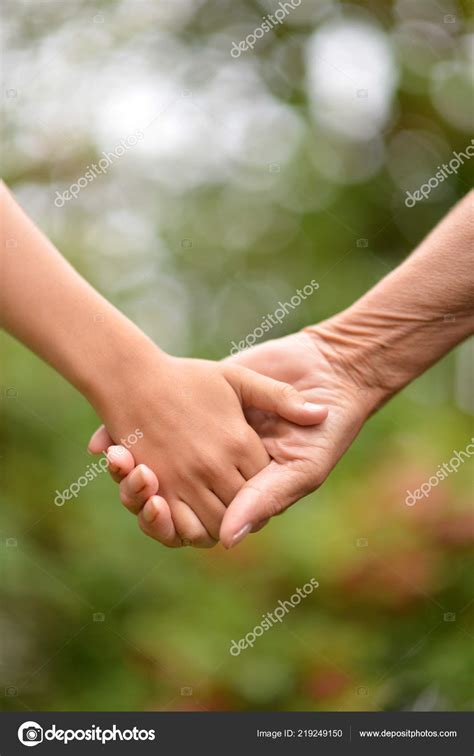 Two People Holding Hands Nature Stock Photo By ©aletia 219249150