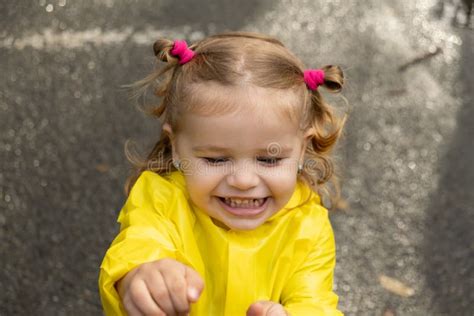 Cute Blonde Baby Girl Toddler Wearing Yellow Stylish Raincoat Closeup
