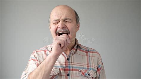 Sleepy Senior Hispanic Man Yawning Being Tired Stock Photo Image Of