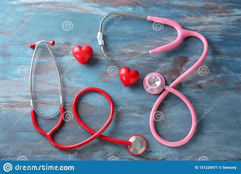 Medical Stethoscopes And Red Hearts On Wooden Background Cardiology