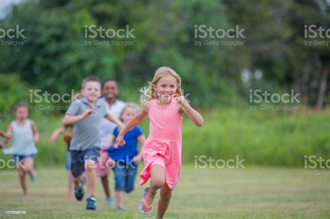 Diverse Group Of Kids Playing Outside Together In The Summer Stock
