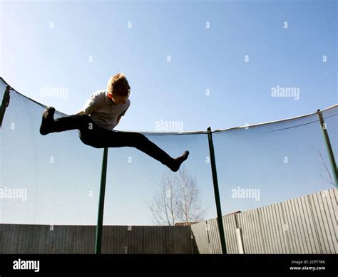 Boy Jumping On A Trampoline Jumping On A Trampoline Stock Photo Alamy