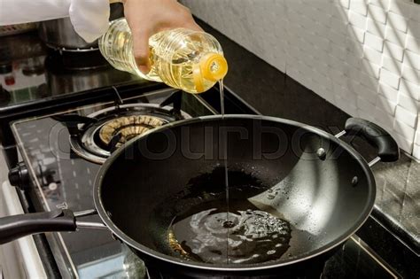 Chef Pouring Oil Into The Frying Pan Stock Image Colourbox