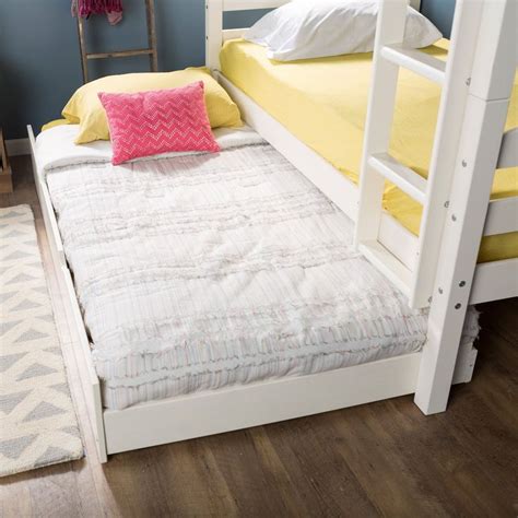 A White Bunk Bed With Yellow And Pink Pillows