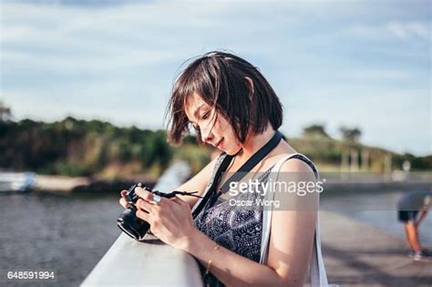 Young Female Photographer Taking Picture In Harbour High Res Stock