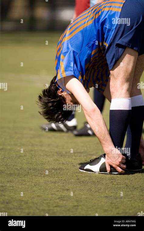 Soccer Player Stretching On Field Stock Photo Alamy