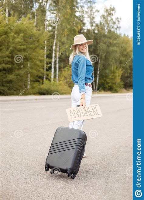 Vertical Smiling Blond Woman Hitchhiker With Carton Plate Anywhere Carrying Roll Aboard Suitcase
