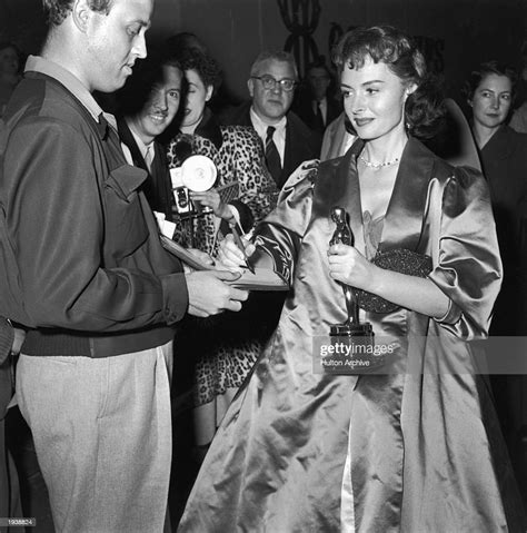 American Actor Donna Reed Signs An Autograph While Holding Her Oscar