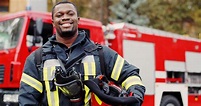 Firefighter portrait on duty. Photo of happy fireman with gas mask and ...