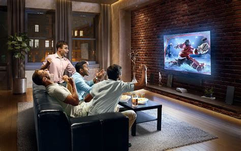 Students Watching Ice Hockey Game On Tv Stock Photo - Download Image ...