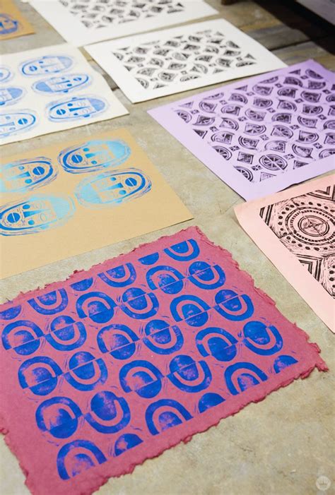Several Different Colored Paper With Designs On Them Sitting On A Table Next To A Printer
