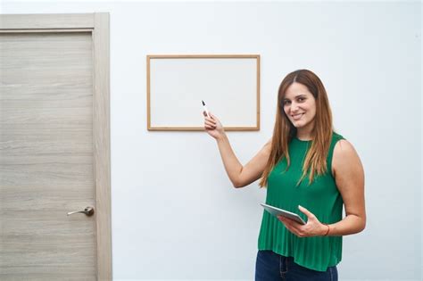 Premium Photo Young Teacher Pointing At A Whiteboard Concept Of