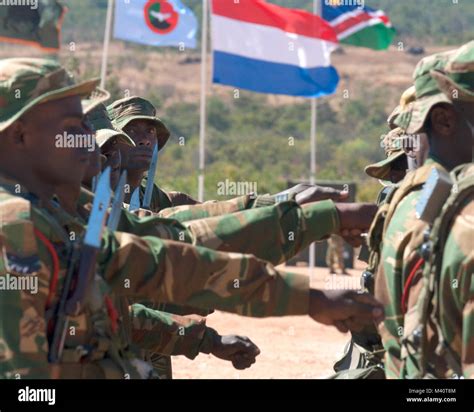 Members Of The Zambian Defense Force March Past Dignitaries During The