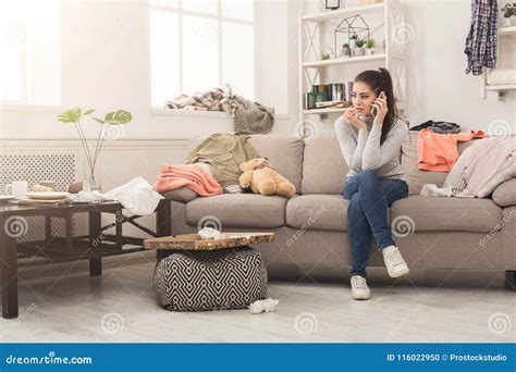 Desperate Woman Sitting On Sofa In Messy Room Stock Photo Image Of