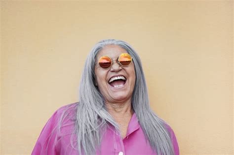 Premium Photo Senior Woman Wearing Hippie Sunglasses While Laughing