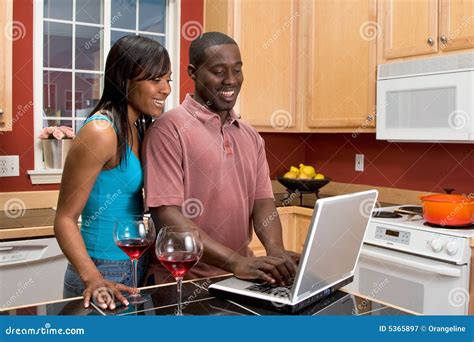 african american couple using laptop in kitchen stock image image of ethnicity adult 5365897