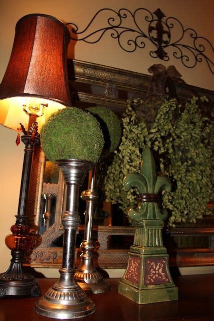 a lamp that is sitting on top of a table next to a potted plant