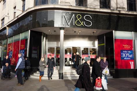 Many People Are Walking In Front Of The M And S Store