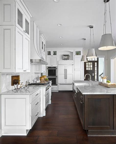 White kitchen cabinet paint colors offer a crisp, classic appearance. White Kitchen with Dark Brown Island and White Marble ...