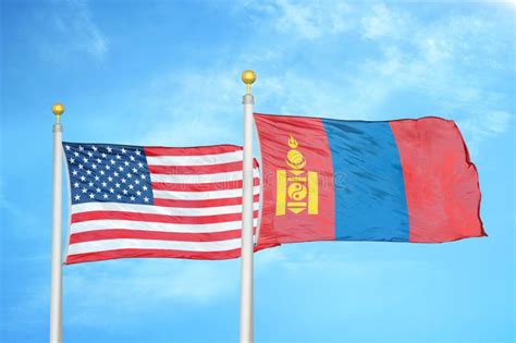 United States And Mongolia Two Flags On Flagpoles And Blue Cloudy Sky