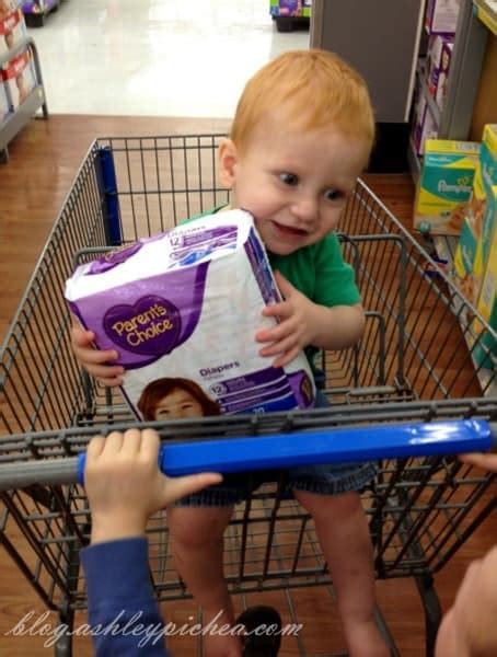 Chris Holding The Parents Choice Diapers At Walmart