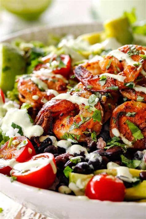 up close of chipotle shrimp burrito bowl drizzled with ...