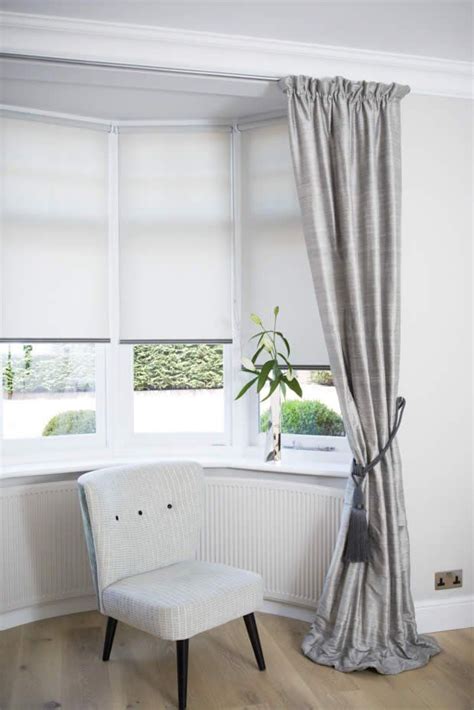A bay window generally looks like a dressing room mirror, with one large front facing mirror and two smaller ones. Curtains & Blinds Bay Windows in 2020 | Bay window living ...