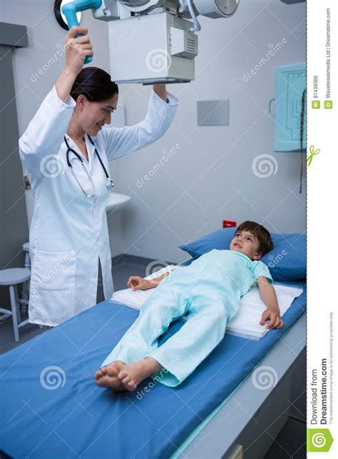 Doctor Adjusting Intravenous Drip For Little Child In Hospital Royalty