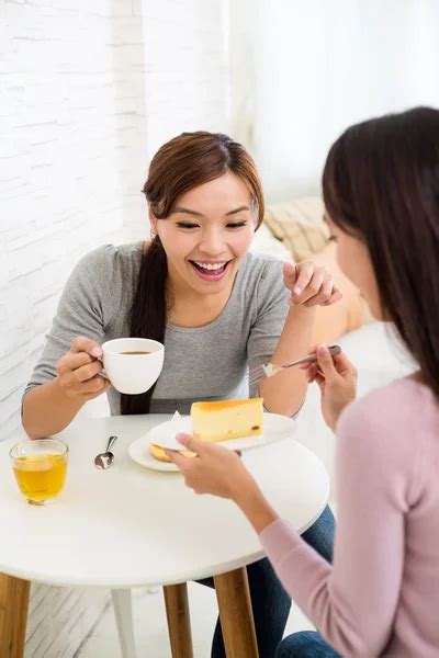Women Talk To Each Other At Coffee Shop Stock Photo By ©leungchopan