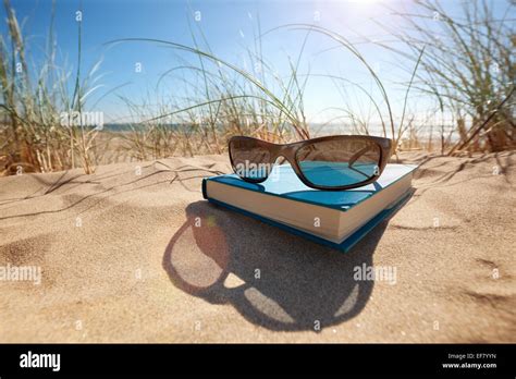 Book And Sunglasses On The Beach Stock Photo Alamy