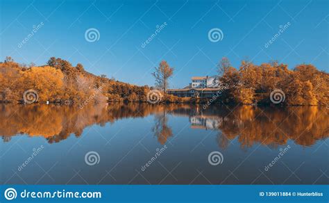 Autumn Colors Forest Woods Yellow Orange Reflecting On Blue Water Lake
