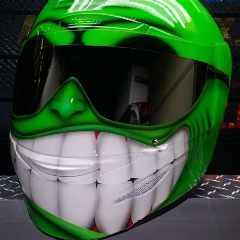 A Green Helmet With White Teeth On It