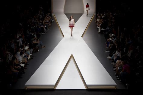 A Woman Walks Down The Runway At A Fashion Show