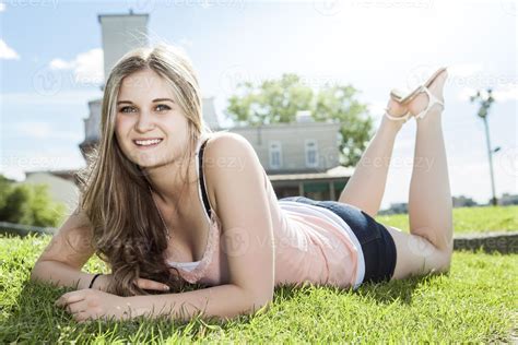 Photo Of Woman Laying In A Grass Field Stock Photo At Vecteezy