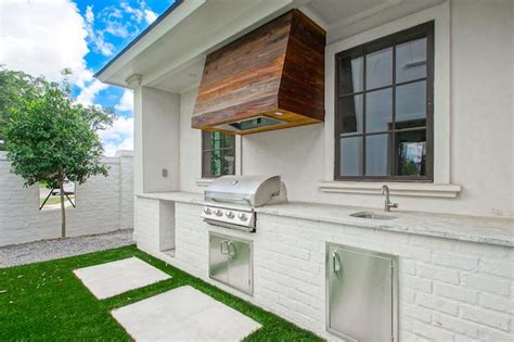 White Brick Outdoor Kitchen With Reclaimed Wood Plank Hood