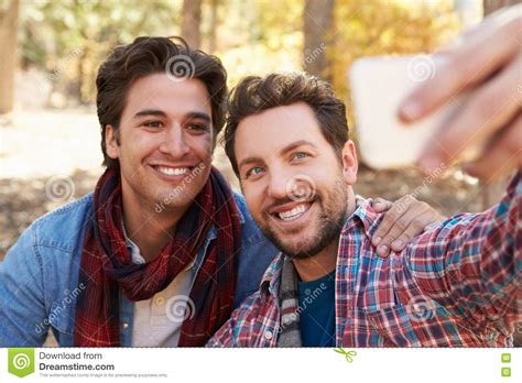 Gay Male Couple Taking Selfie On Walk In Woodland Stock Image Image
