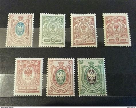 six different colored stamps on display in a glass case all with the same design