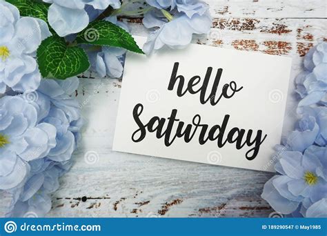 Hello Saturday Card With Blooming Flower On Wooden Background Stock