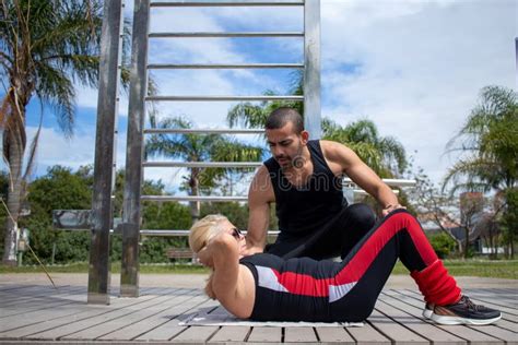 Blonde Lady Exercising With Her Personal Trainer Stock Image Image Of