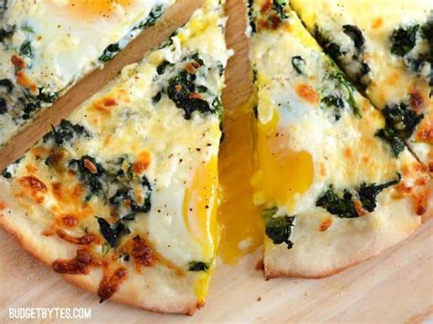 I make homemade pizza a lot, with a variety of toppings, but one that always makes an impression is the egg topping on pizza florentine. Eggs Florentine Breakfast Pizza Recipe - Budget Bytes