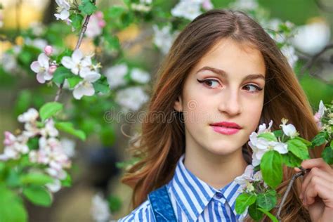 Pretty Teen Girl Are Posing In Garden Near Blossom Tree With White