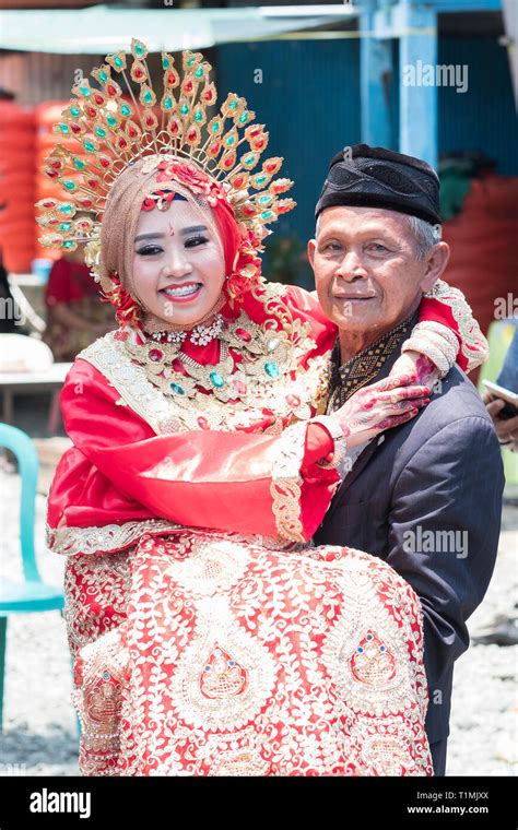 A Father And His Newly Married Daughter Wearing A Traditional Sulawesi