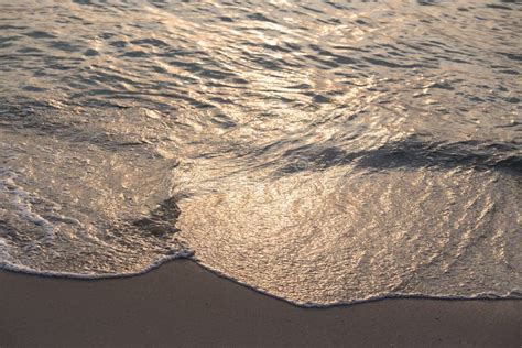 Sunrise Reflect On Sea Wave And Beach Of Tropical Sea Stock Photo