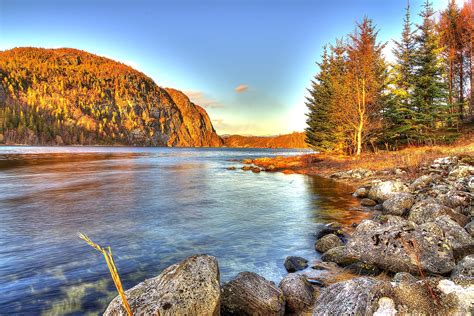 River In The Middle Of Mountain And Green Trees Under Blue Sky During