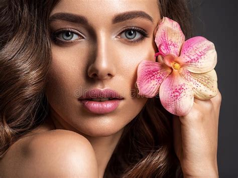 Stunning Girl Holds Flower Near Eyes Beautiful Woman With Brown Hair
