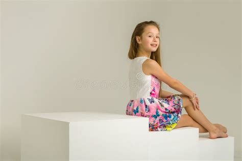 Little Girl Sitting White Cube Cross Legged Stock Photos Free