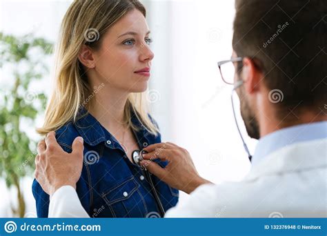 Handsome Young Male Doctor Checking Beautiful Young Woman Patient